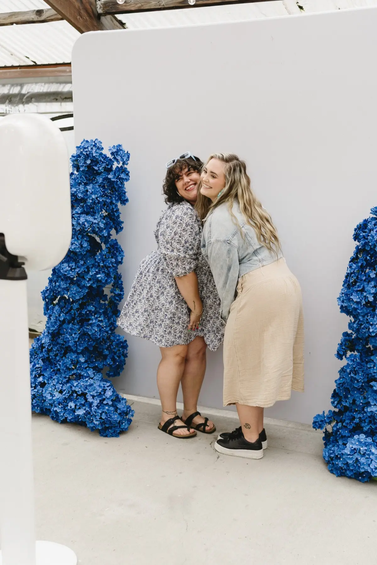 Open air photo booth rental setup at a Los Angeles wedding with blue backdrop