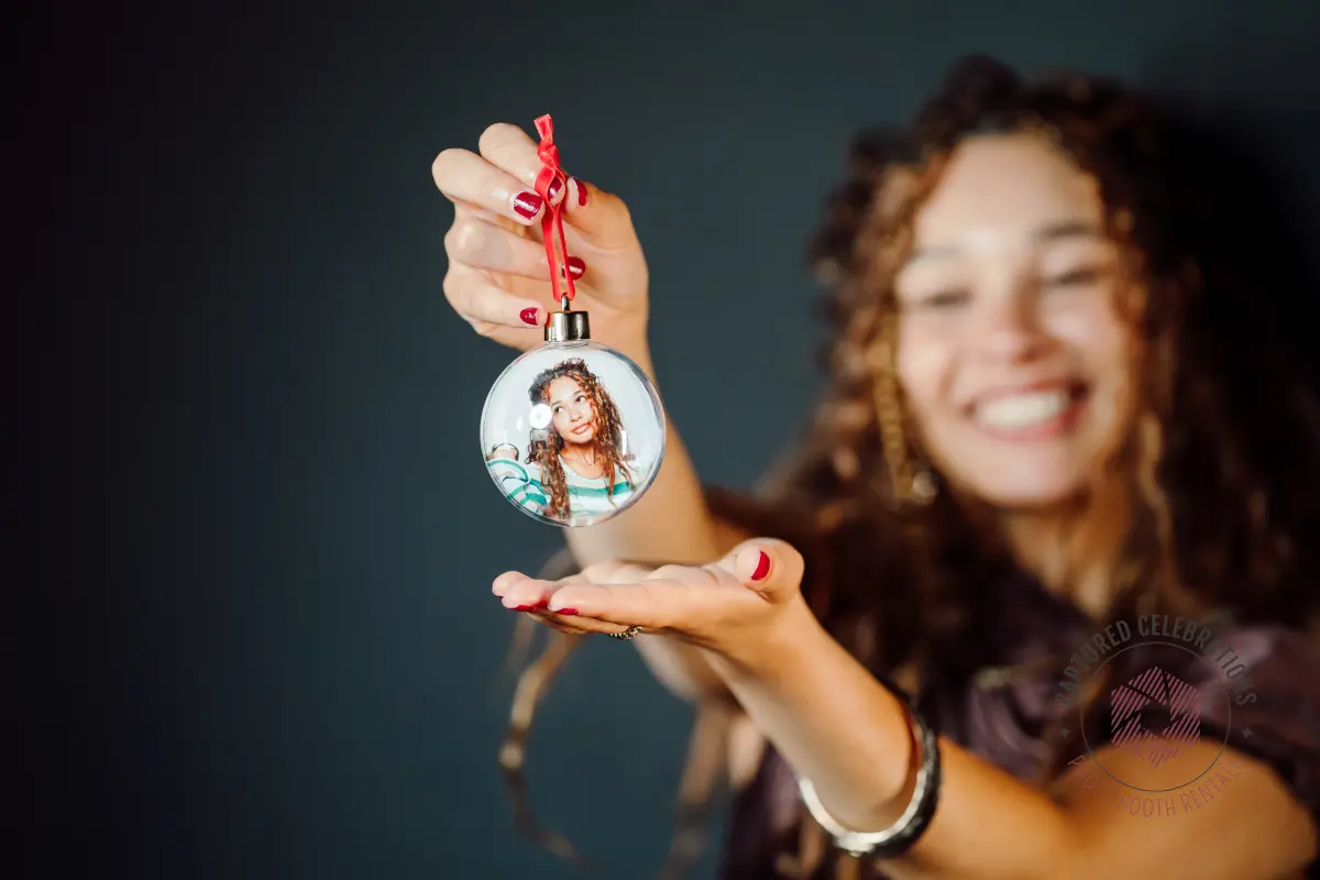 Guest holding a photo ornament keepsake made at a Captured Celebrations holiday photo booth in Los Angeles