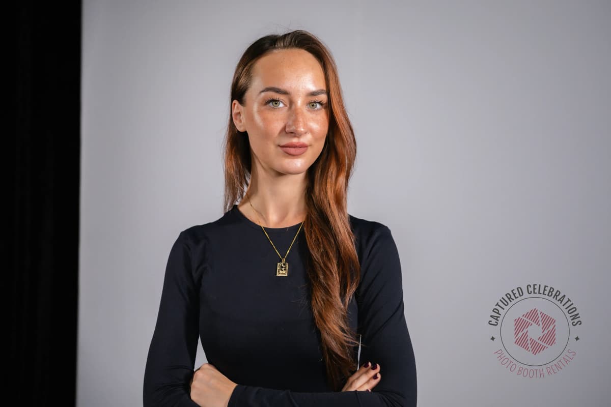 Professional headshot portrait of woman with arms crossed taken at on-site LA headshot station