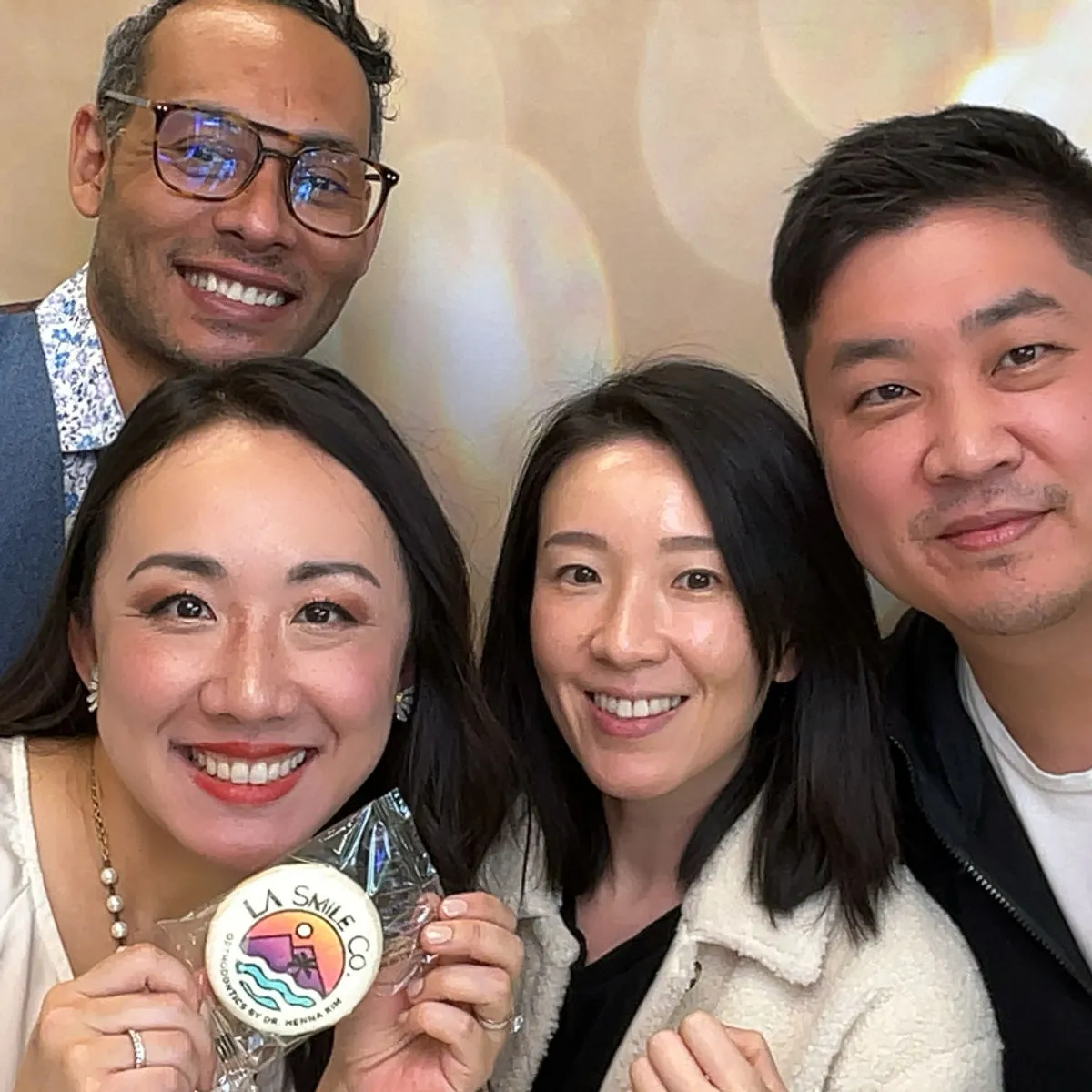 Guests holding a branded keepsake at a corporate photo booth activation in Los Angeles
