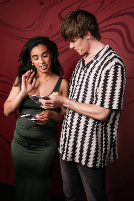 Excited guests showing off trading cards at Los Angeles party — Captured Celebrations