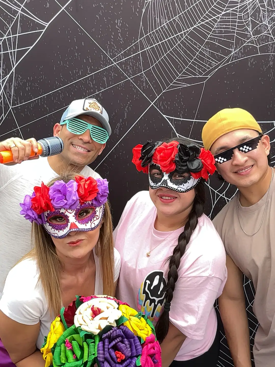 Friends in Halloween costumes at photo booth
