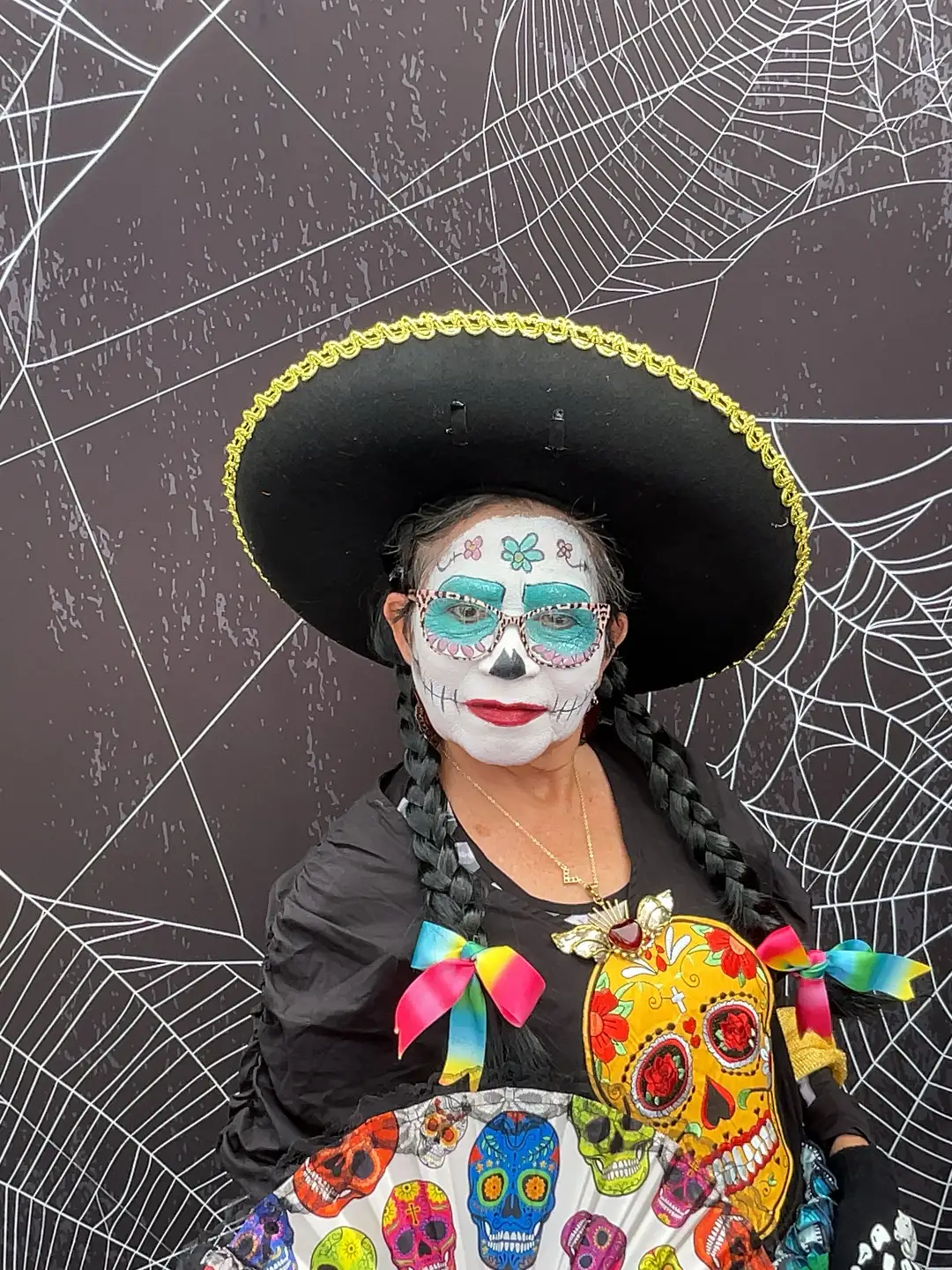 Woman in Catrina costume with skull prop