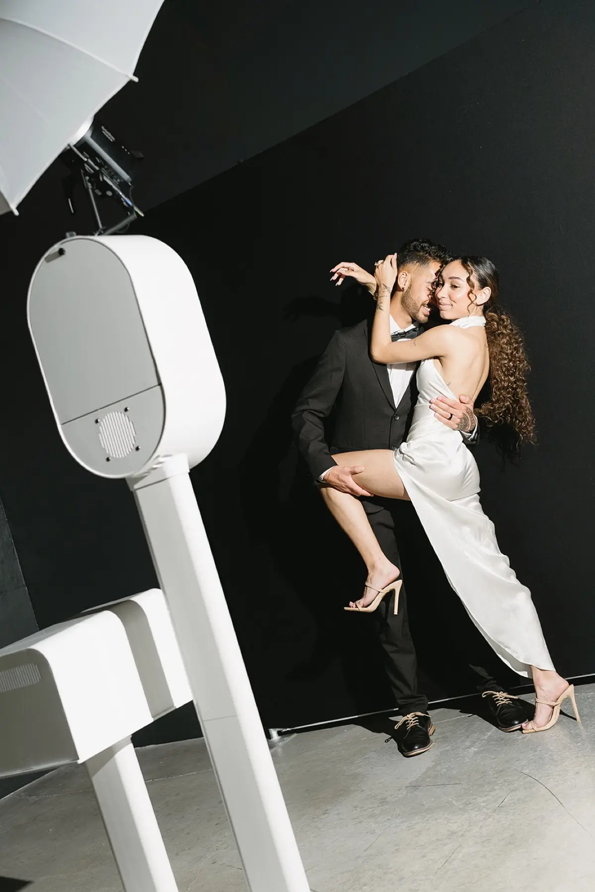 Late-night photo booth party with neon glow and confetti at a high-energy wedding reception