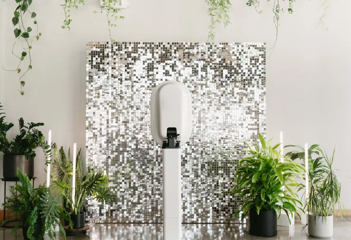 Shimmer plants photo booth with elegant backdrop
