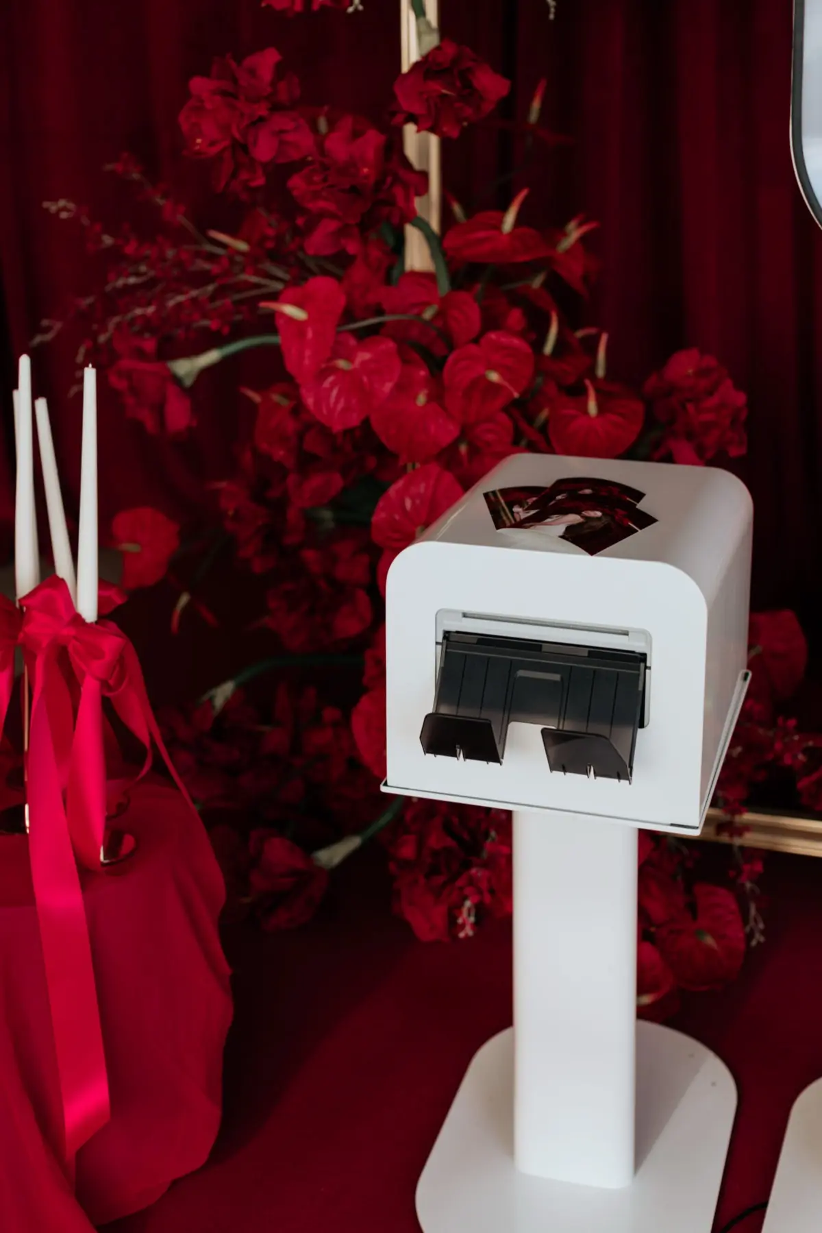 Red carpet photo booth event with velvet ropes and professional step-and-repeat backdrop